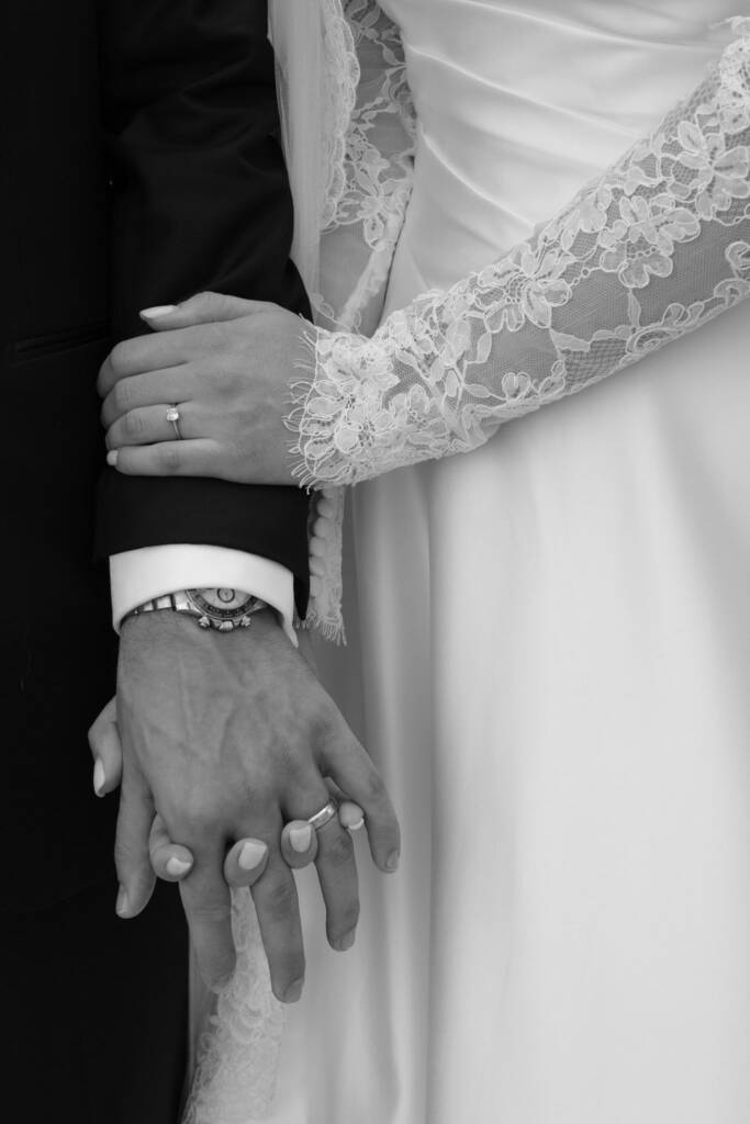 couple holding hands in front of reddish heritage walls at Al Seef Dubai